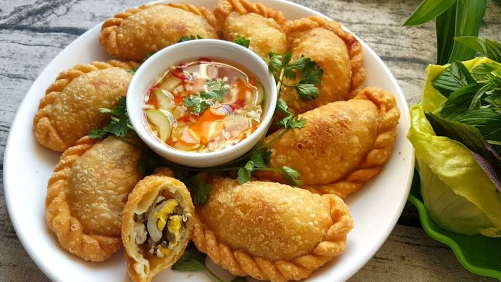 Bánh gối Sapa - bánh đặc sản Sapa với lớp vỏ chiên giòn, nhân cà rốt, thịt, nấm mèo và trứng cút, món ăn vặt ấm lòng ngày mưa lạnh.